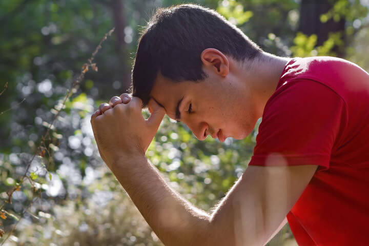 Man Praying in Nature