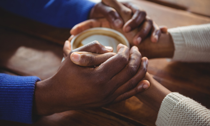 Black Christian Dating Close up of couple holding hands